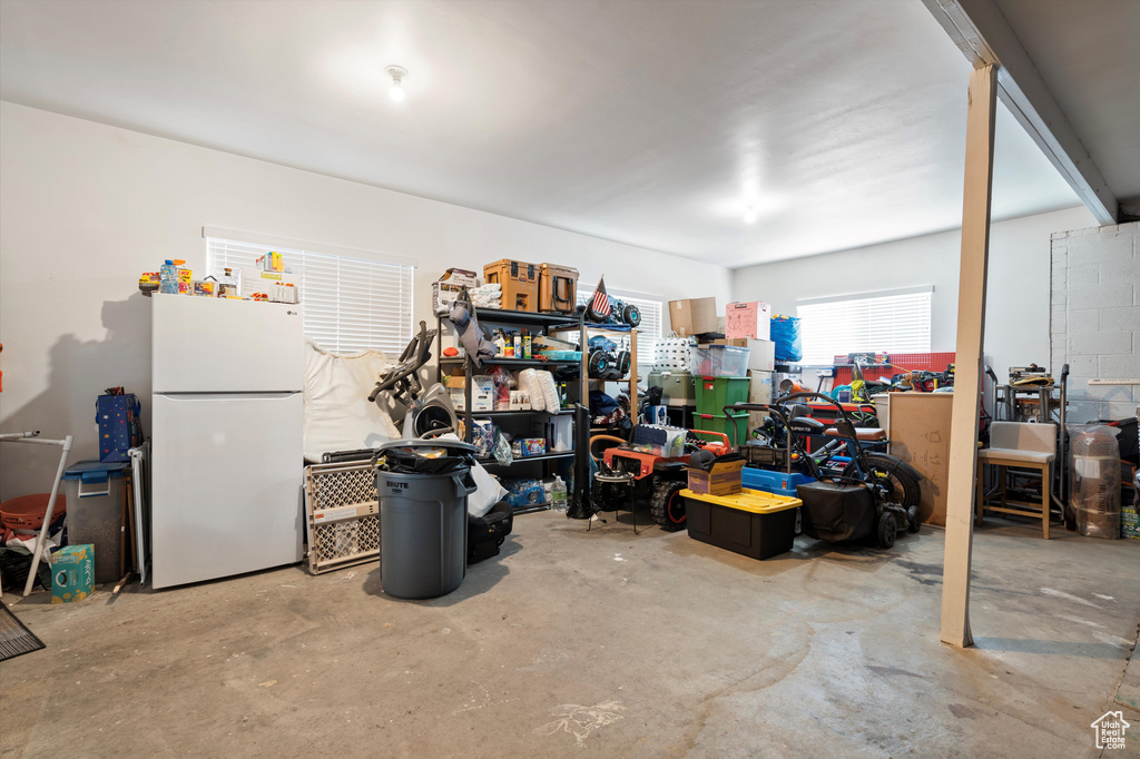 Garage featuring white refrigerator