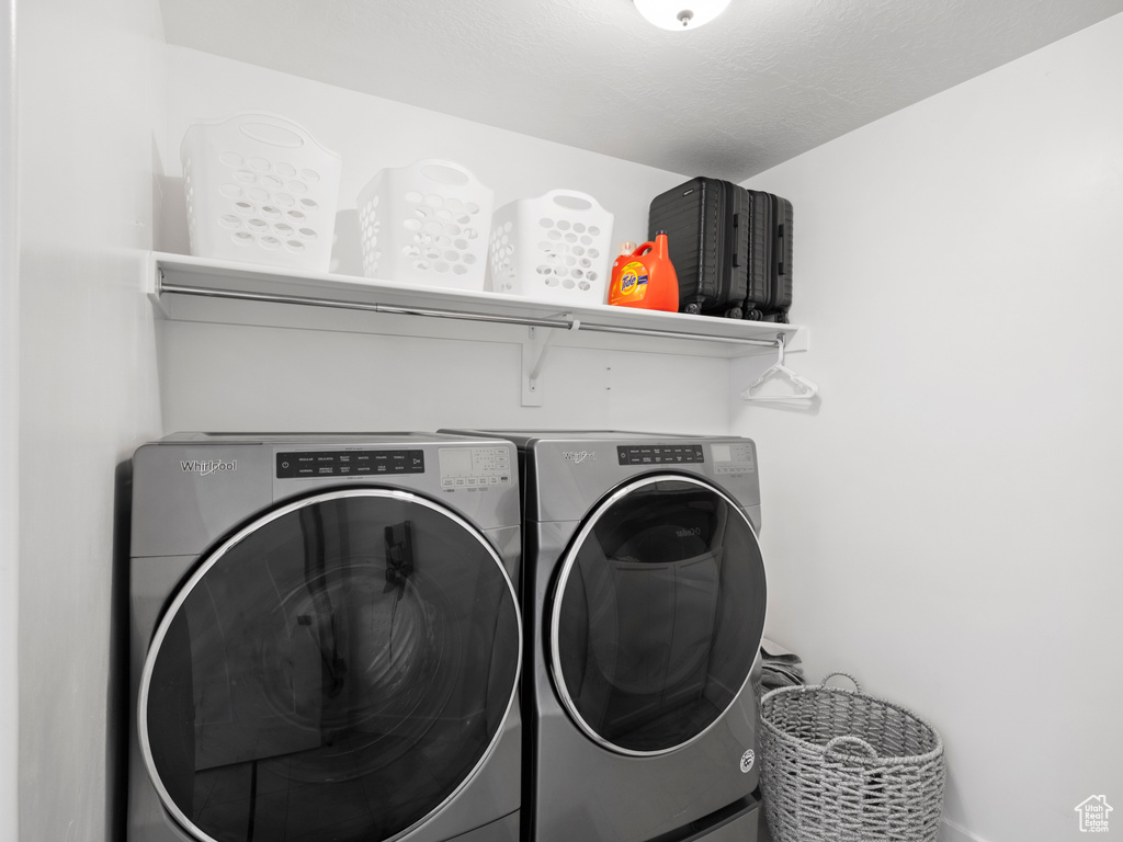 Clothes washing area featuring washing machine and dryer