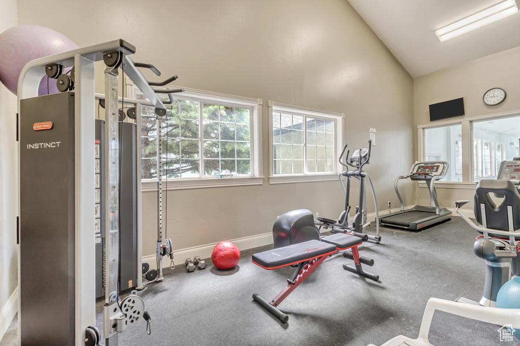 Workout area featuring carpet floors and vaulted ceiling