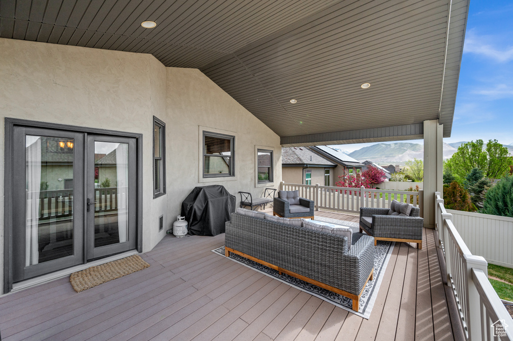 Wooden deck featuring a grill, french doors, and an outdoor hangout area