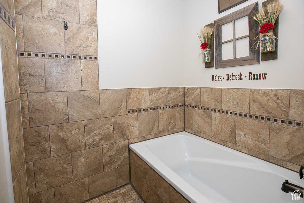 Bathroom featuring tile walls and tile floors
