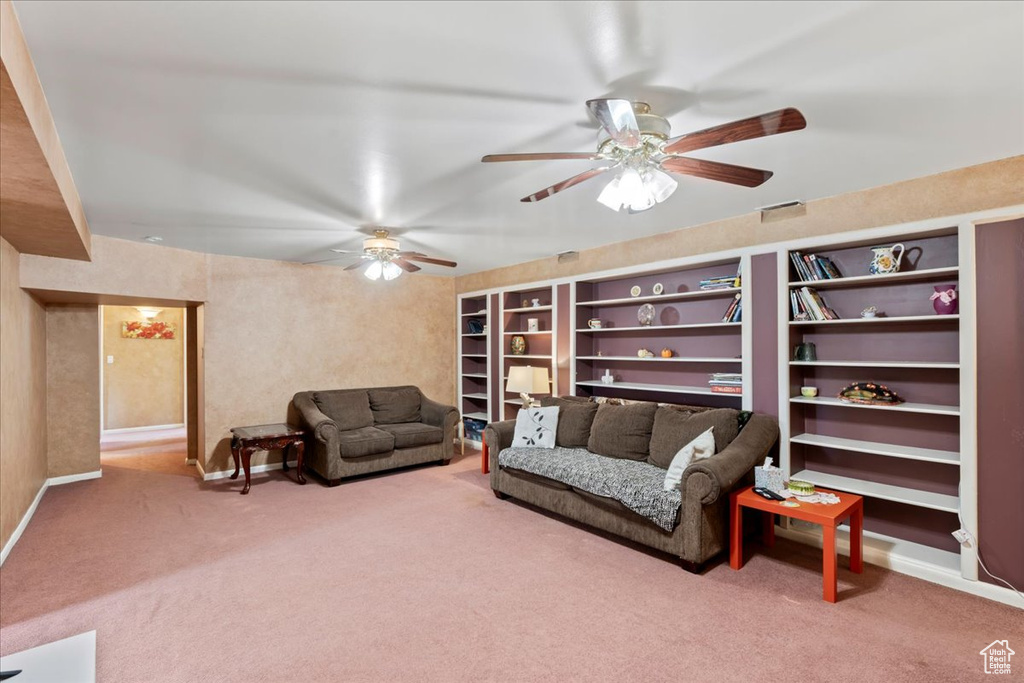 Living room featuring built in features, ceiling fan, and carpet floors