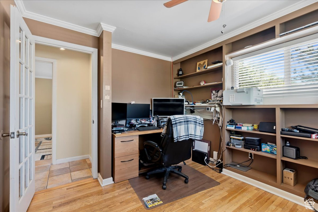 Office space featuring ornamental molding, ceiling fan, and light wood-type flooring