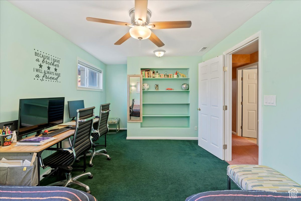 Office space with ceiling fan and dark carpet