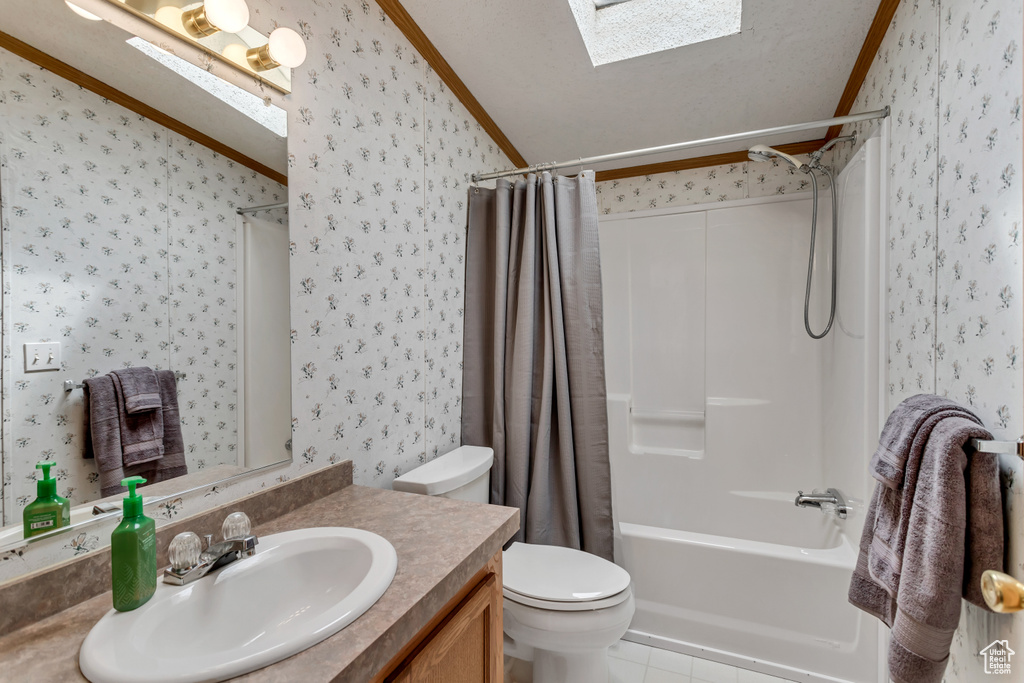 Full bathroom featuring shower / bathtub combination with curtain, large vanity, toilet, tile flooring, and a skylight