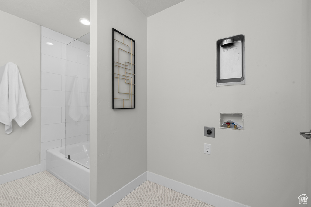 Bathroom featuring tiled shower / bath and tile floors