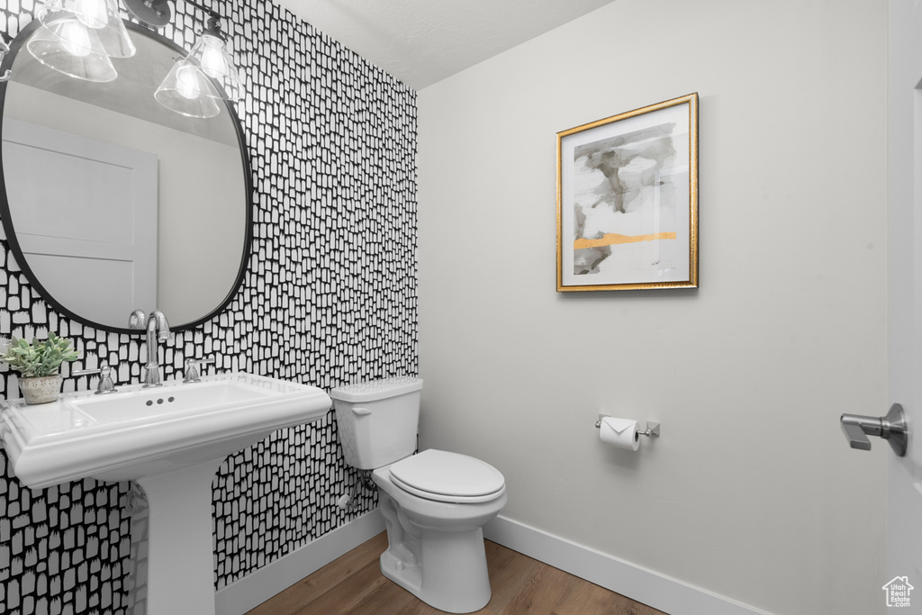 Bathroom with tile walls, hardwood / wood-style floors, tasteful backsplash, and toilet
