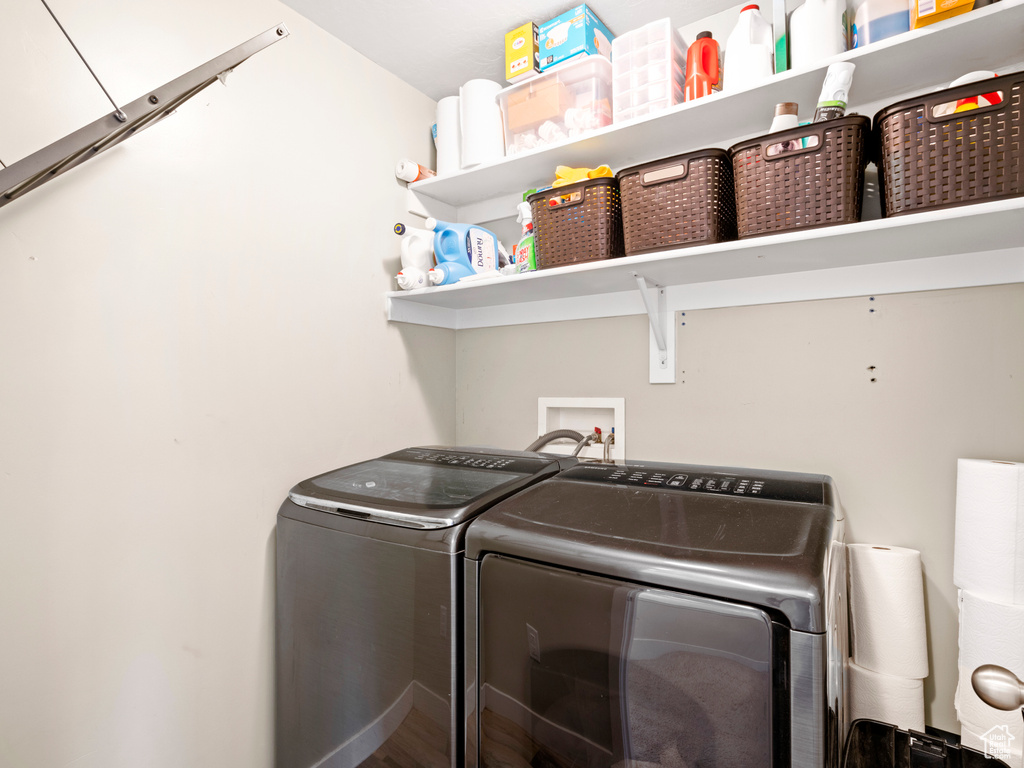 Laundry room featuring independent washer and dryer and hookup for a washing machine