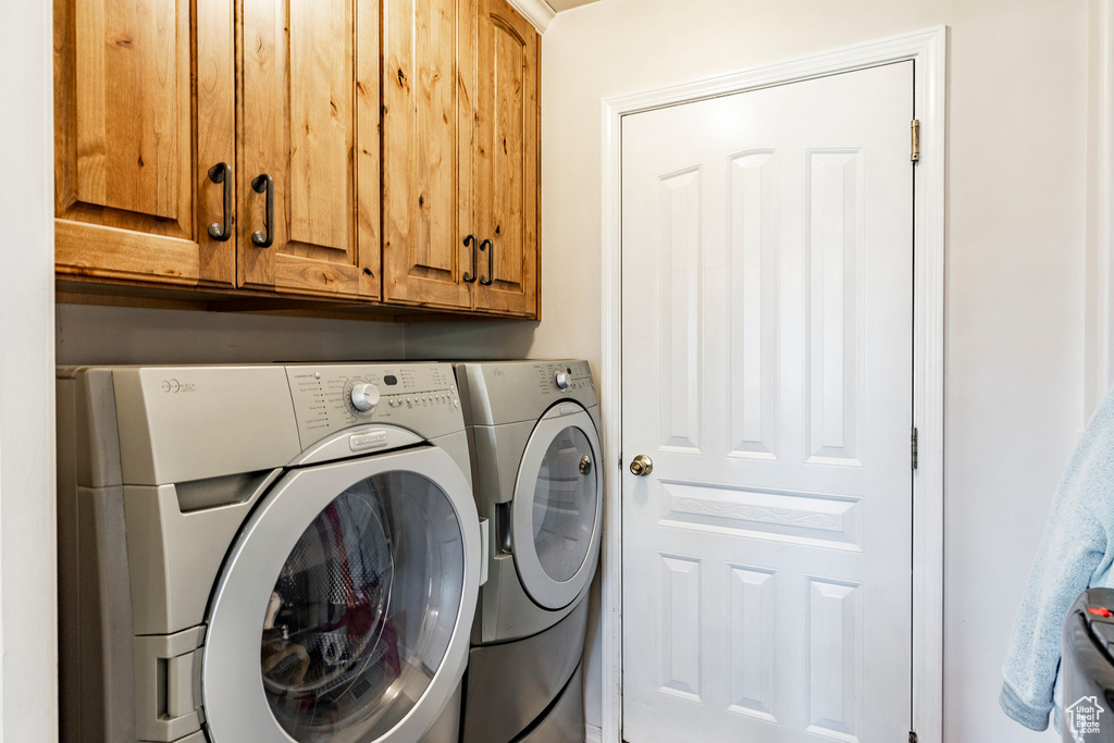 Laundry room with cabinets and separate washer and dryer
