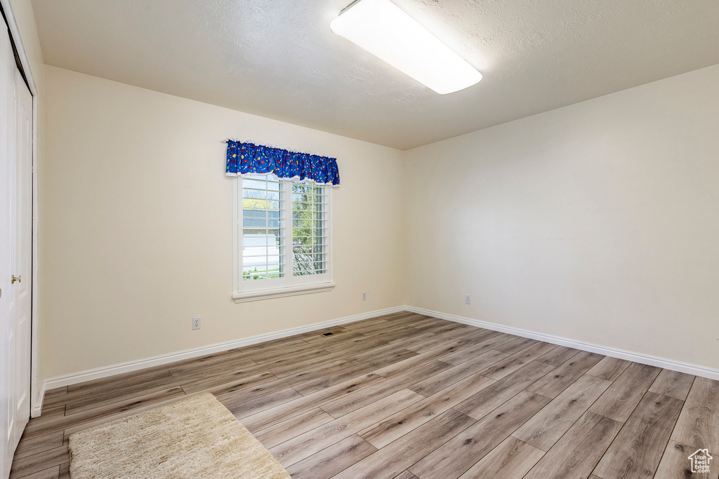 Empty room featuring light wood-type flooring