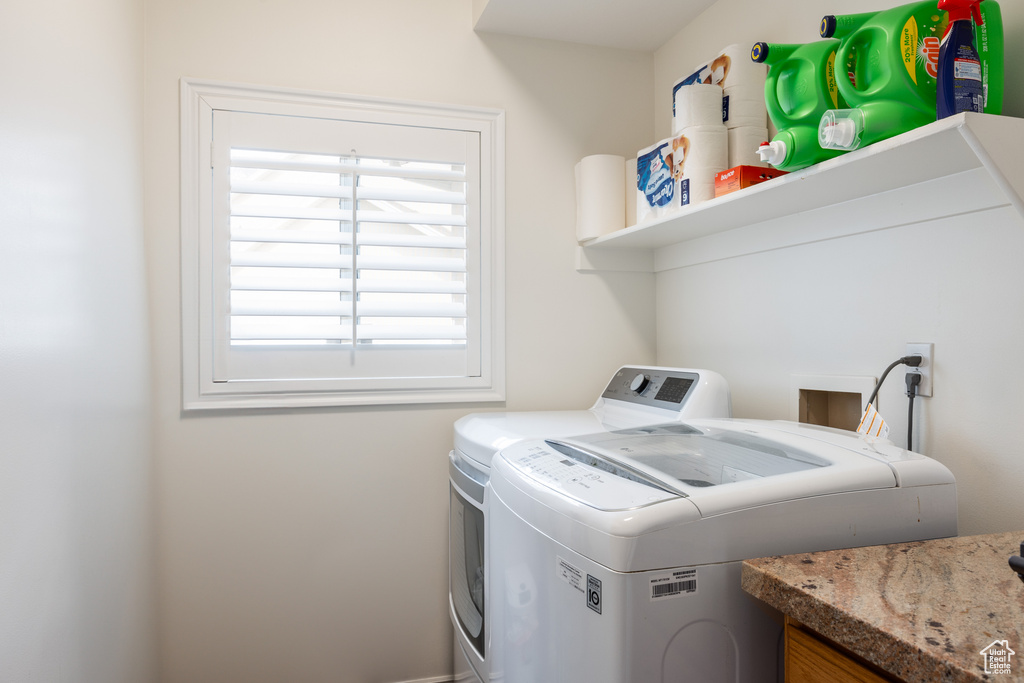 Washroom featuring washer hookup and washing machine and dryer