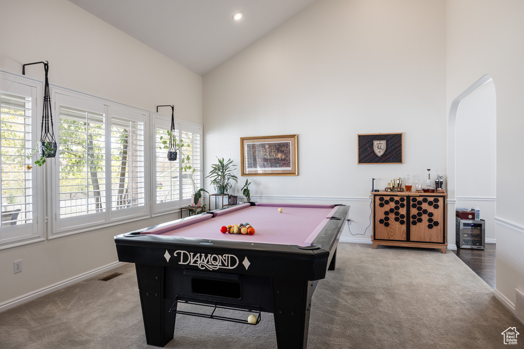 Recreation room featuring high vaulted ceiling, hardwood / wood-style floors, and pool table