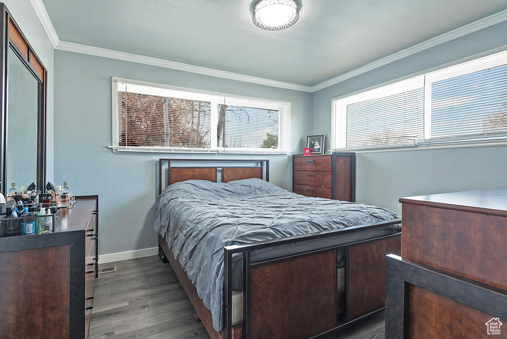 Bedroom featuring crown molding and hardwood / wood-style flooring