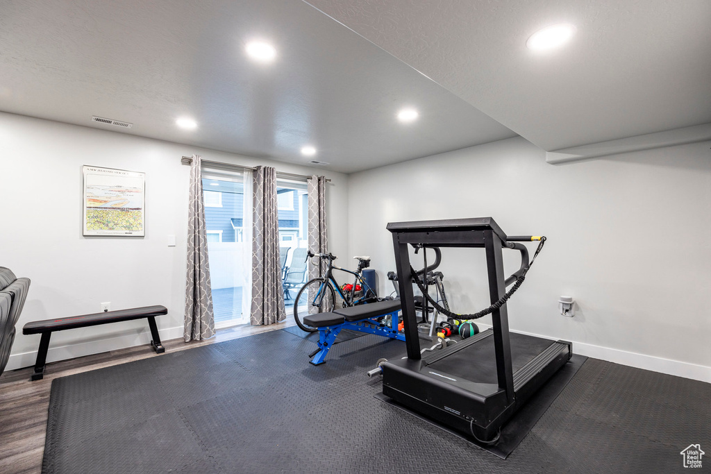 Workout room featuring dark hardwood / wood-style flooring