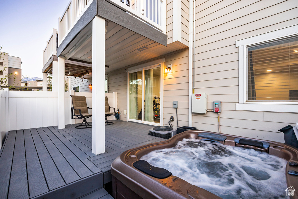 Deck featuring an outdoor hot tub