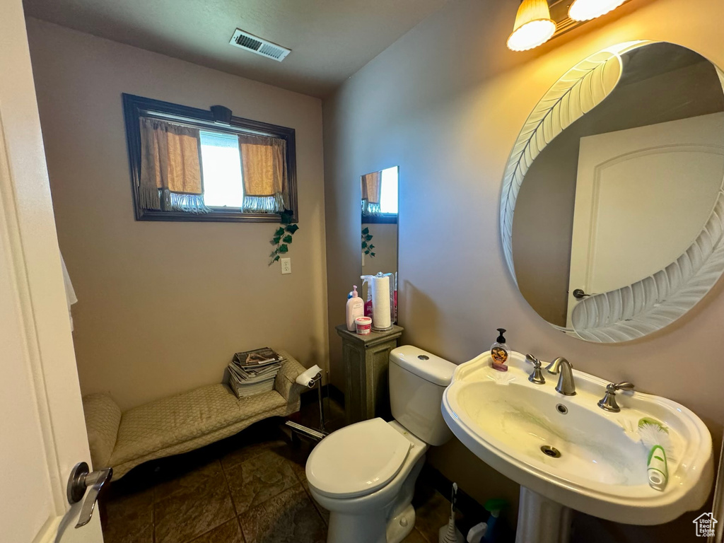 Bathroom with tile flooring, sink, and toilet