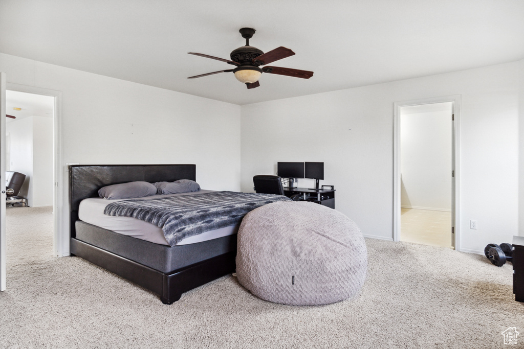 Bedroom featuring carpet floors, ceiling fan, and ensuite bathroom