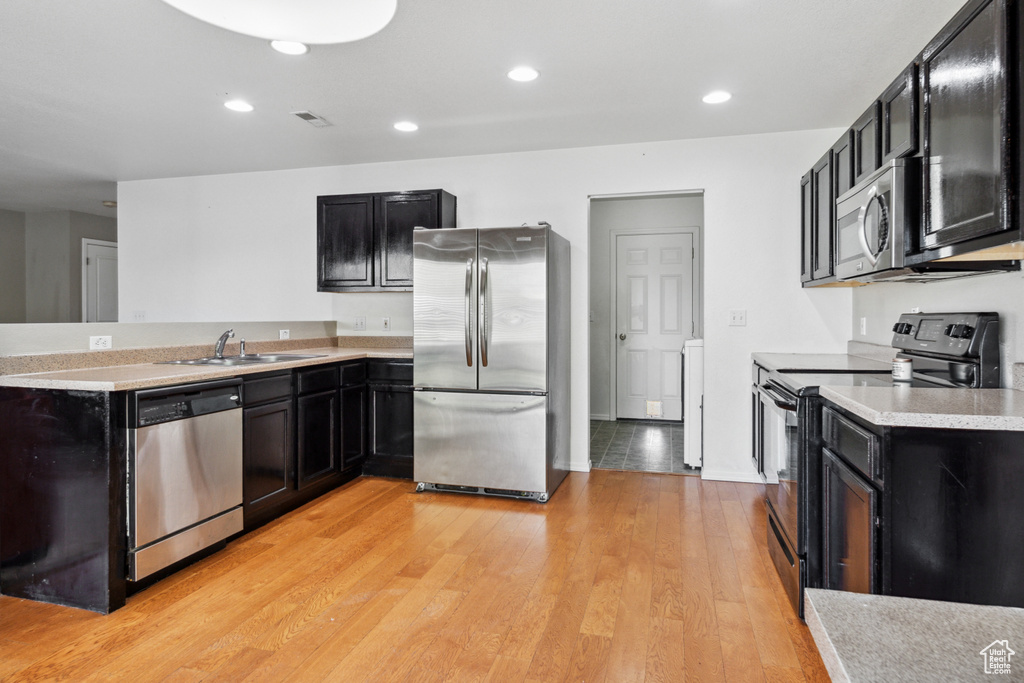 Kitchen featuring sink, light hardwood / wood-style floors, and stainless steel appliances