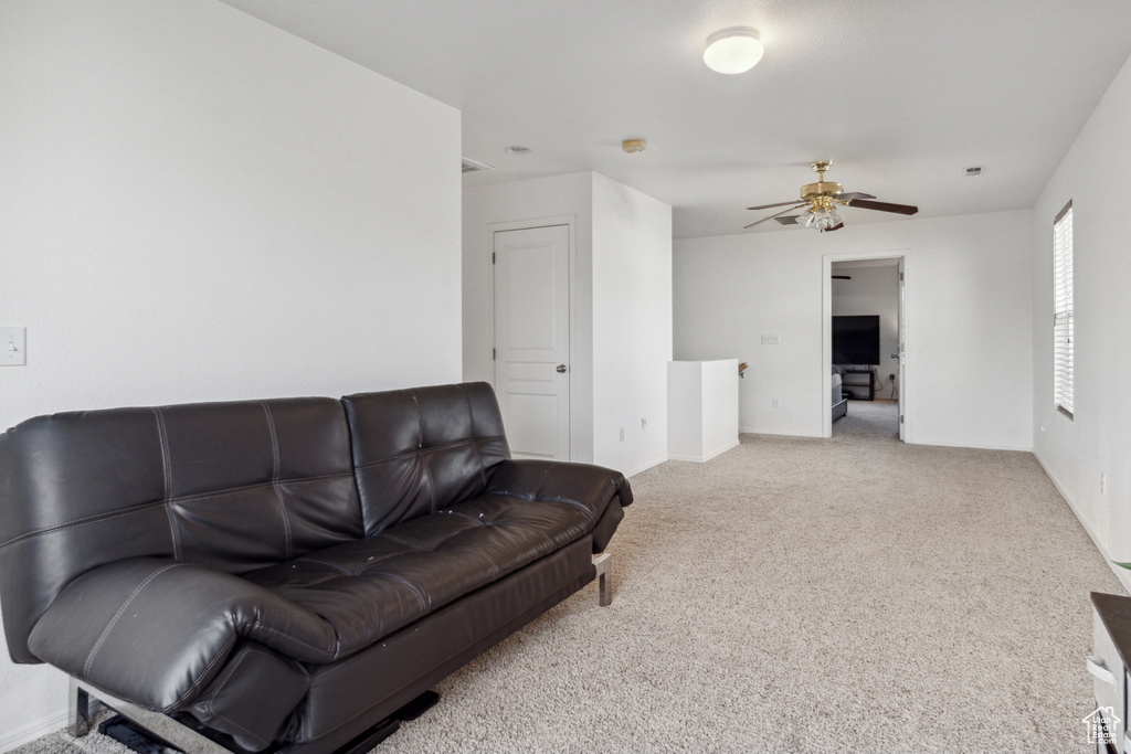 Living room featuring ceiling fan and carpet floors