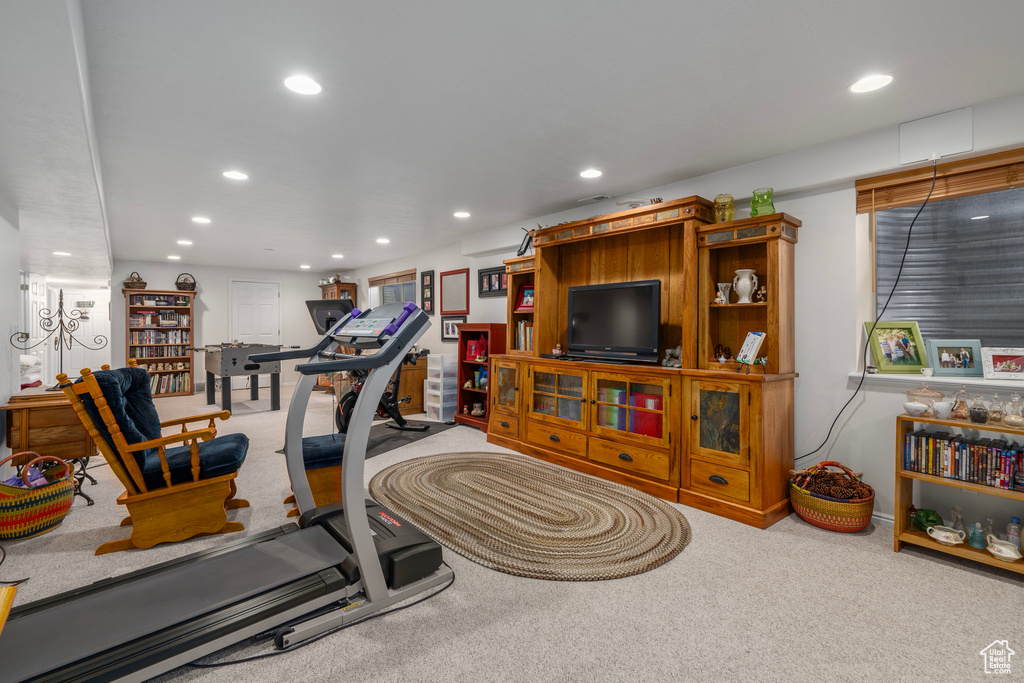Exercise area featuring light colored carpet