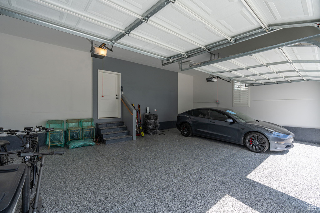 Garage featuring a carport and a garage door opener