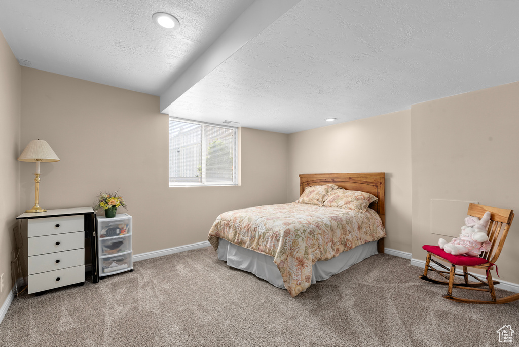 Bedroom featuring a textured ceiling and carpet floors