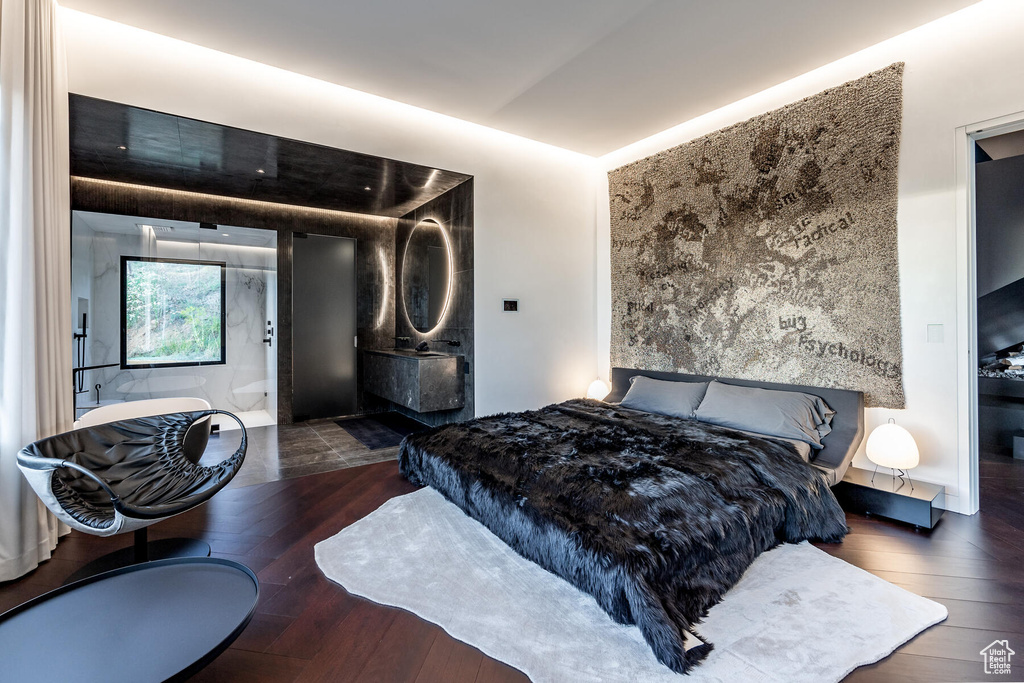Bedroom with dark hardwood / wood-style floors