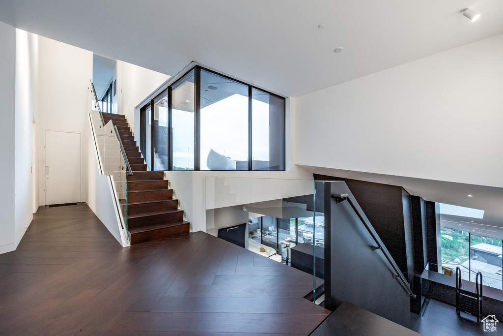 Staircase with dark parquet flooring