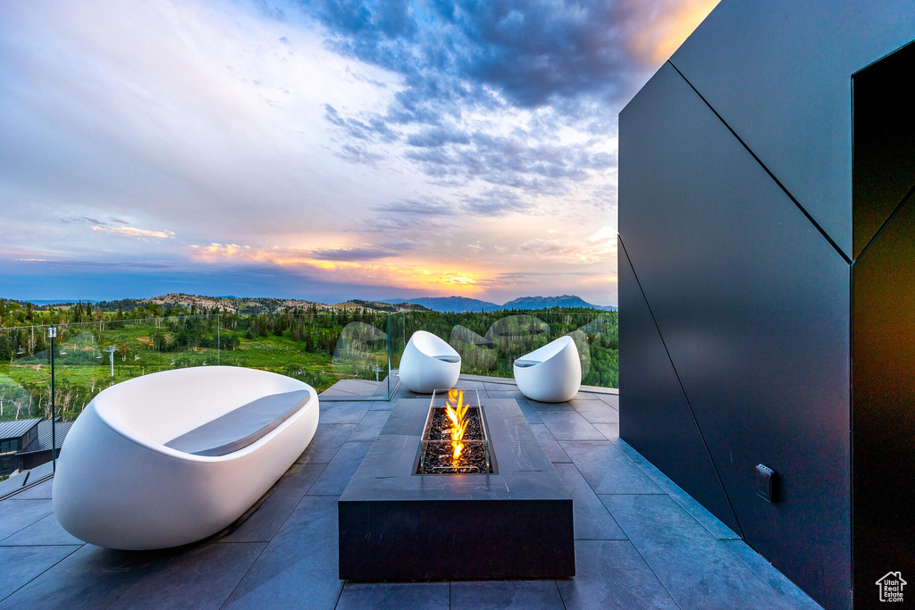 Patio terrace at dusk with a fire pit
