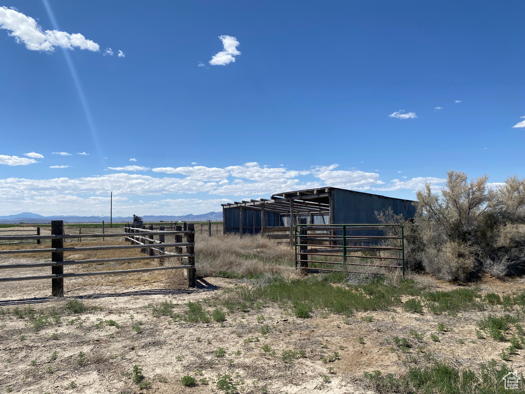 View of yard with a rural view and an outdoor structure