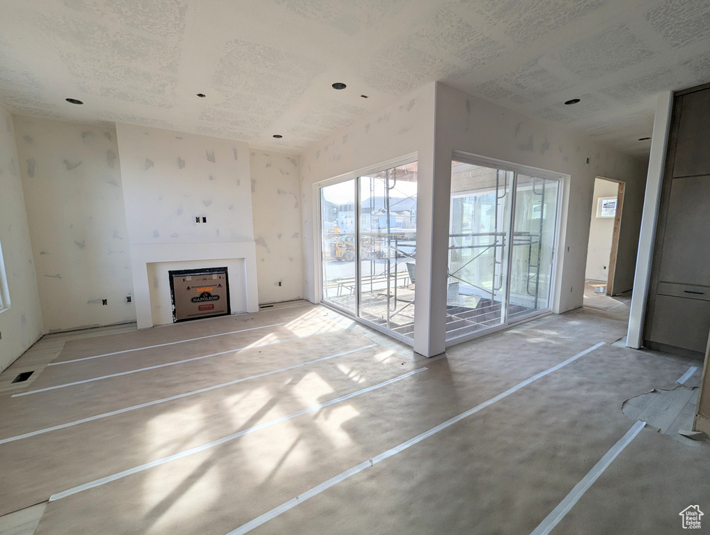 Unfurnished living room featuring concrete floors