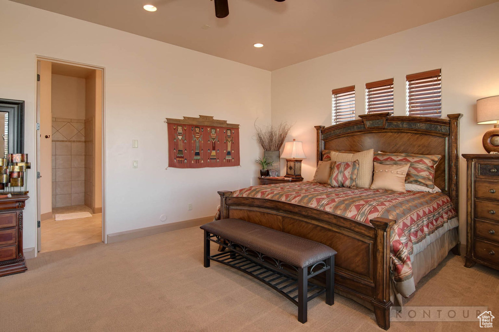 Bedroom featuring carpet, ceiling fan, and ensuite bathroom
