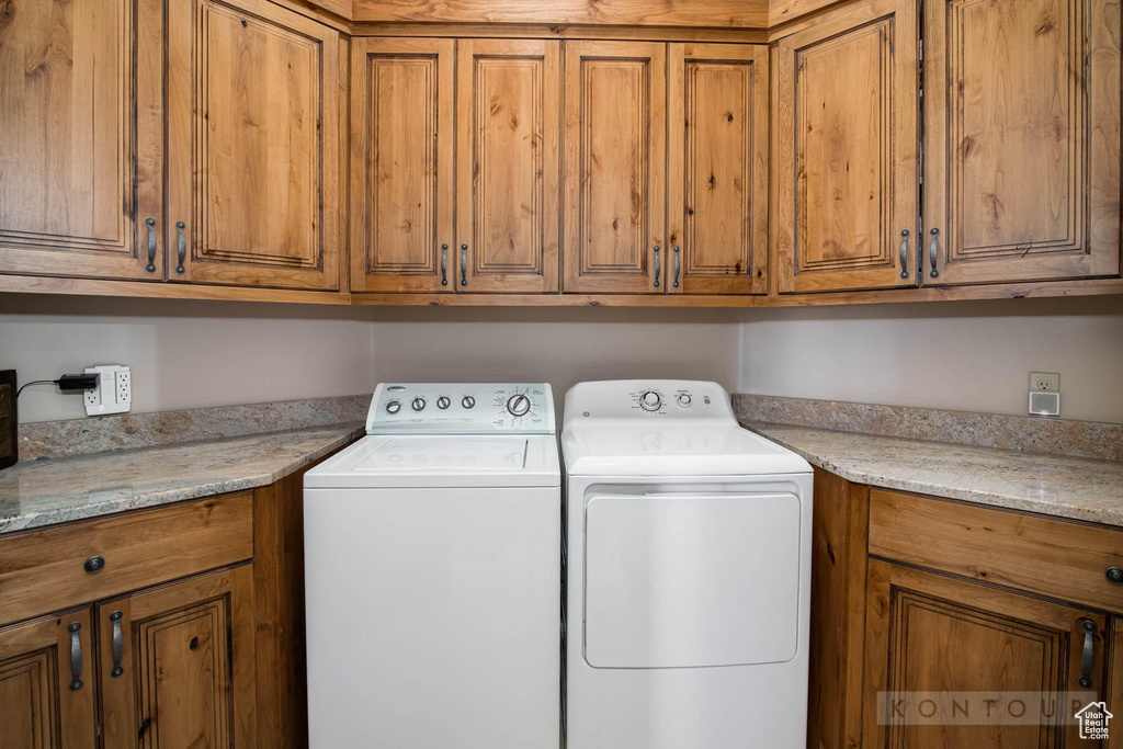 Clothes washing area with washer and dryer and cabinets