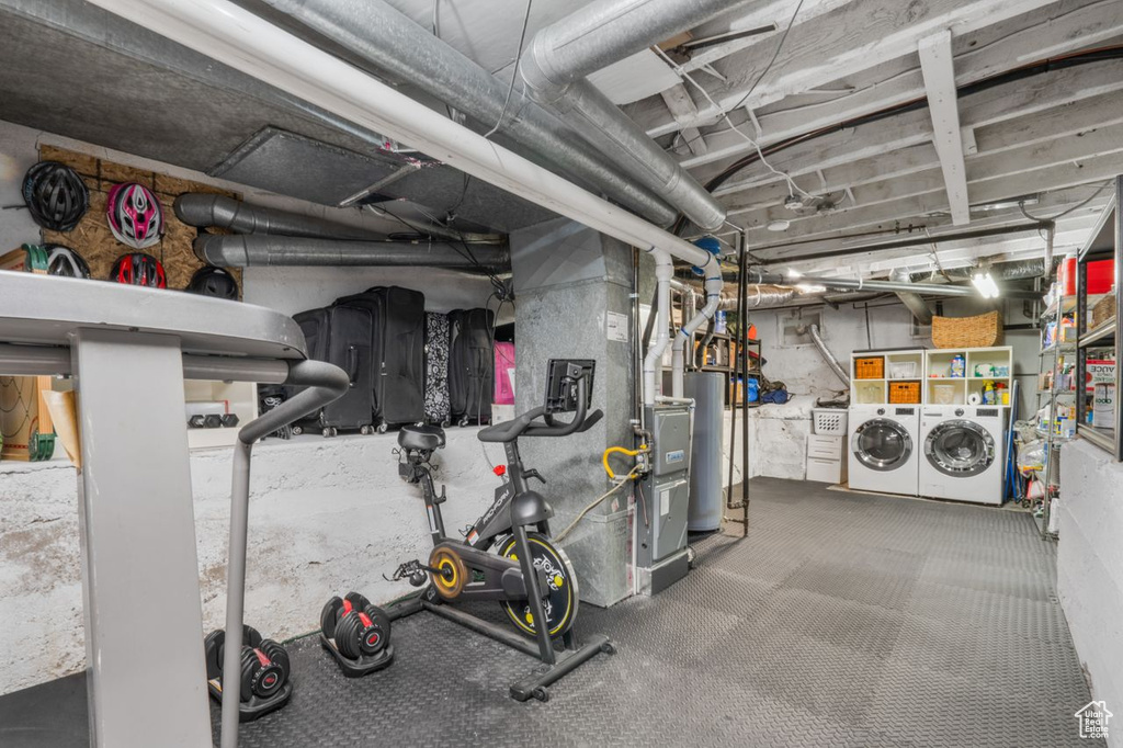 Basement featuring water heater and washer and dryer