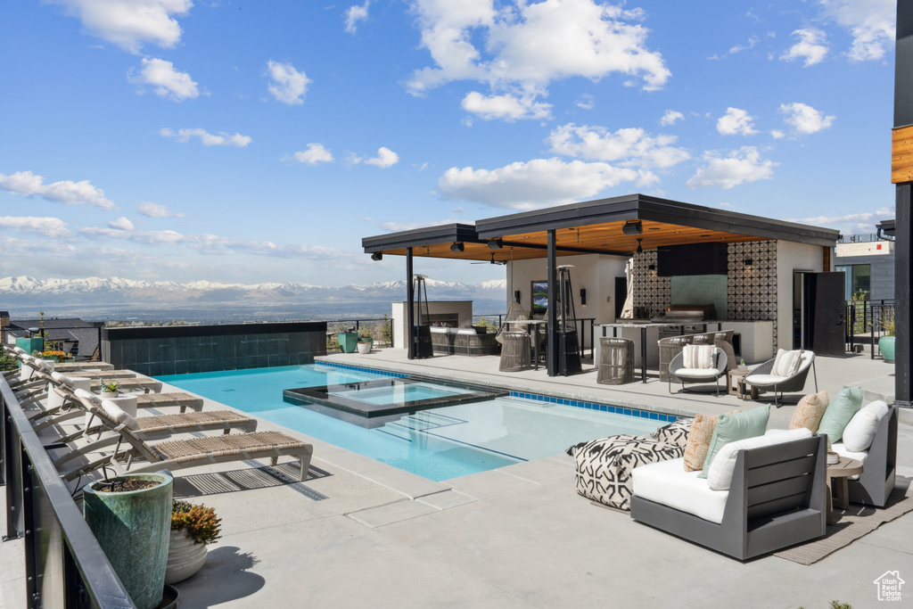 View of swimming pool featuring a patio and an outdoor hangout area