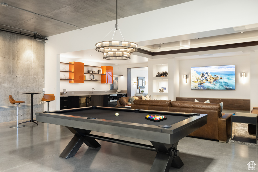 Game room featuring billiards and a chandelier