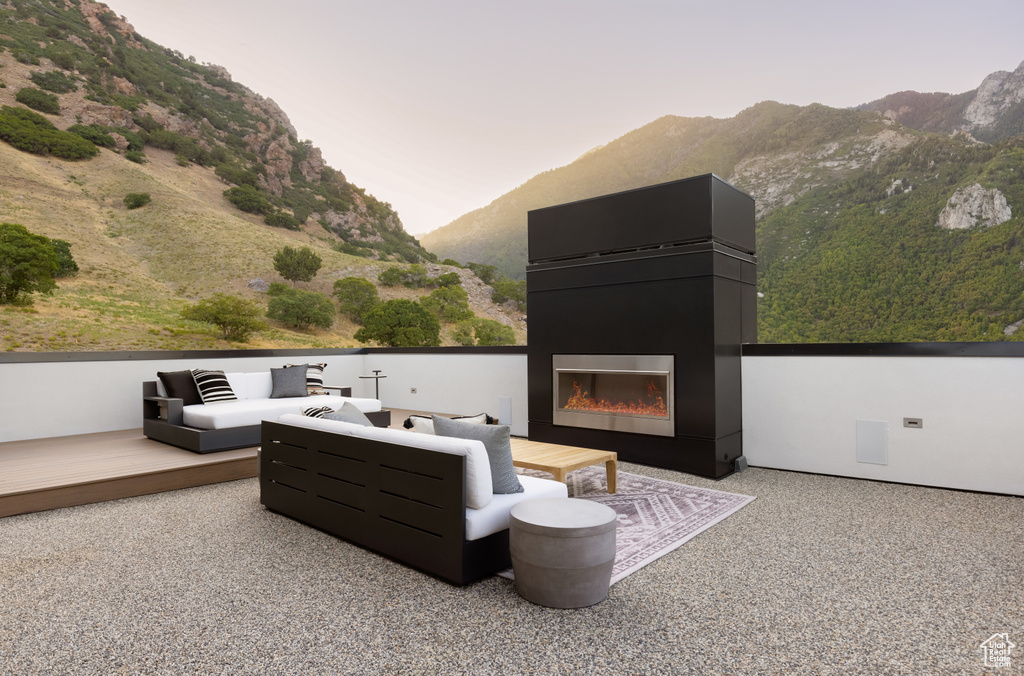 Exterior space featuring an outdoor living space with a fireplace and a mountain view