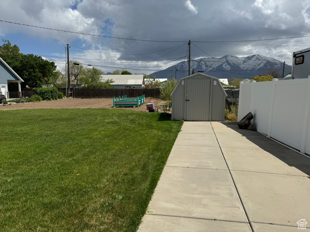 View of yard with a shed and a mountain view