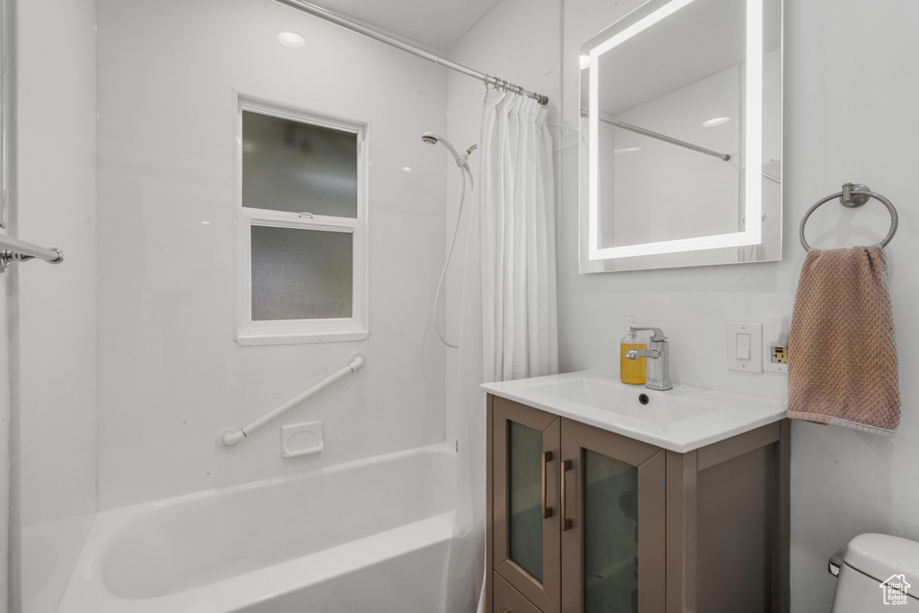 Full bathroom with shower / bath combination with curtain, toilet, and vanity