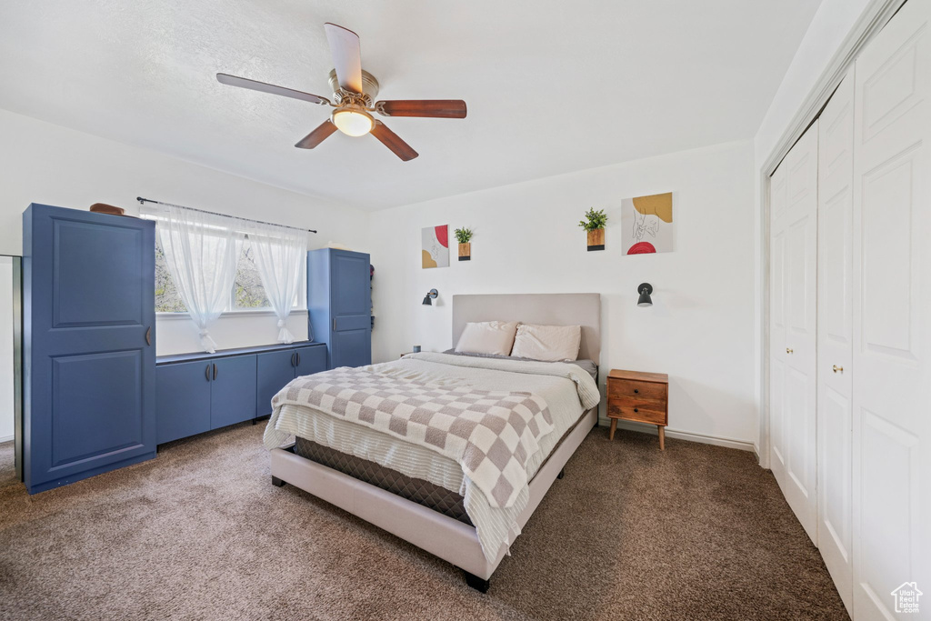 Bedroom featuring a closet, ceiling fan, and carpet flooring