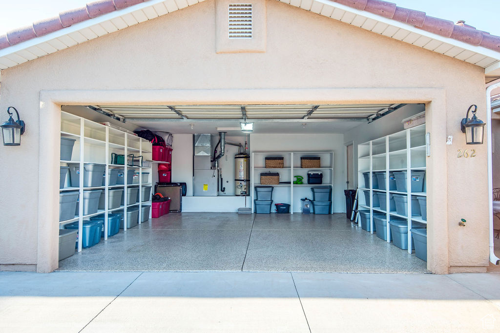 Garage featuring secured water heater and heating utilities