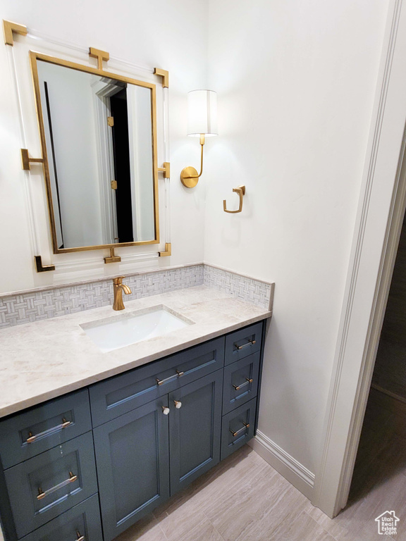 Bathroom with vanity and wood-type flooring