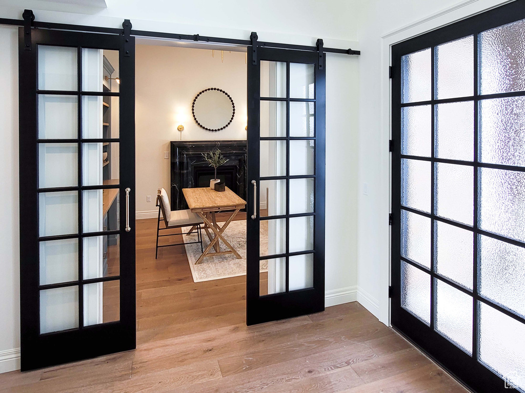 Doorway featuring a barn door and hardwood / wood-style flooring