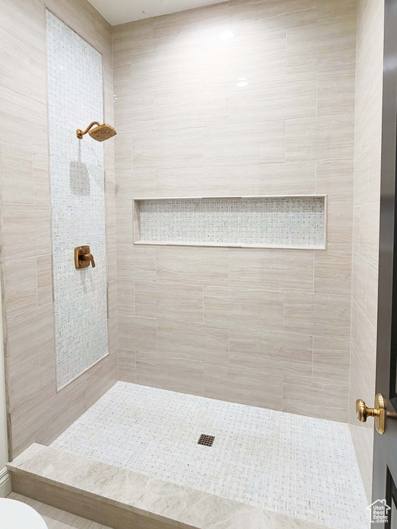 Bathroom with toilet and tiled shower