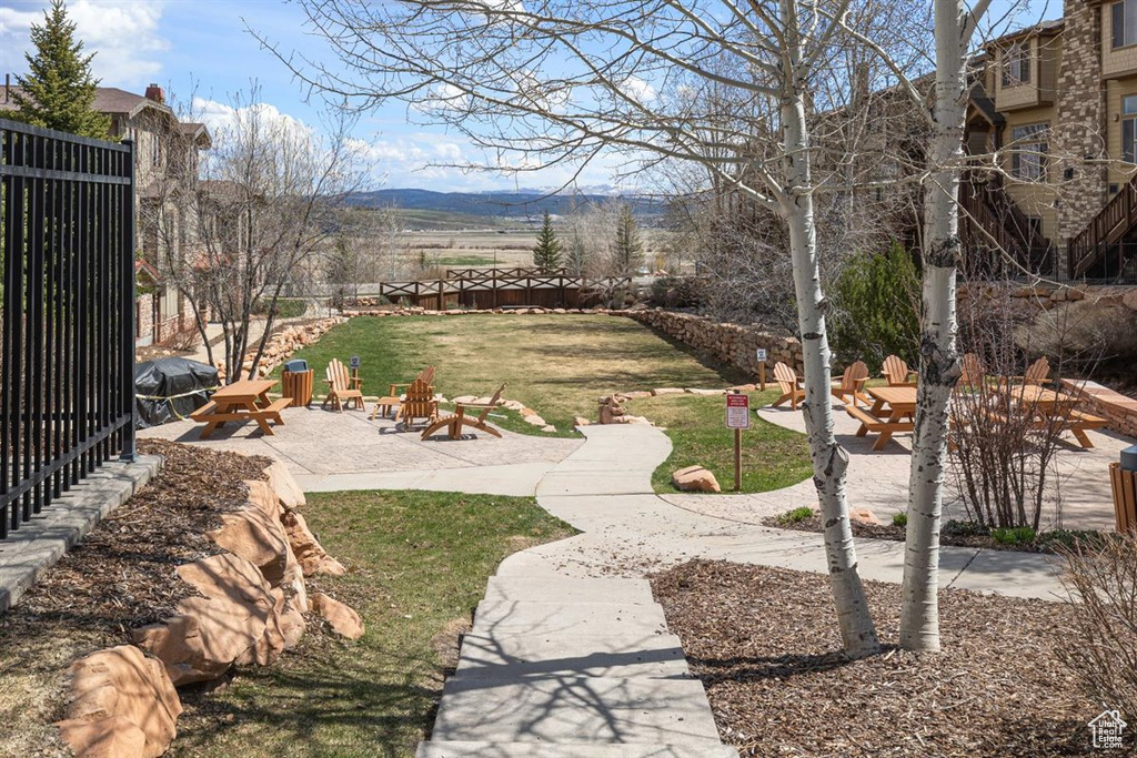 View of yard featuring a patio, a mountain view, and an outdoor fire pit