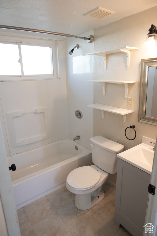 Full bathroom featuring tile floors, toilet, bathtub / shower combination, and vanity