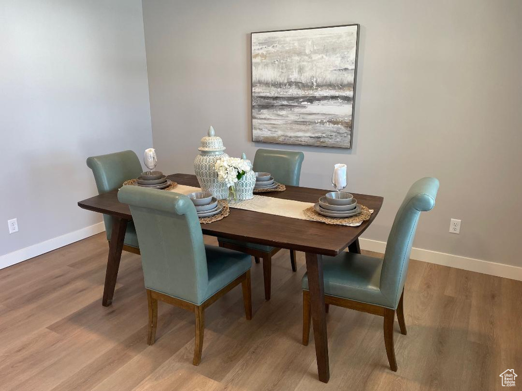 Dining space with hardwood / wood-style flooring