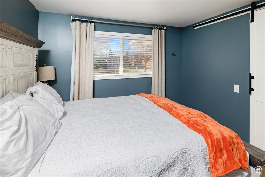 Bedroom featuring a barn door