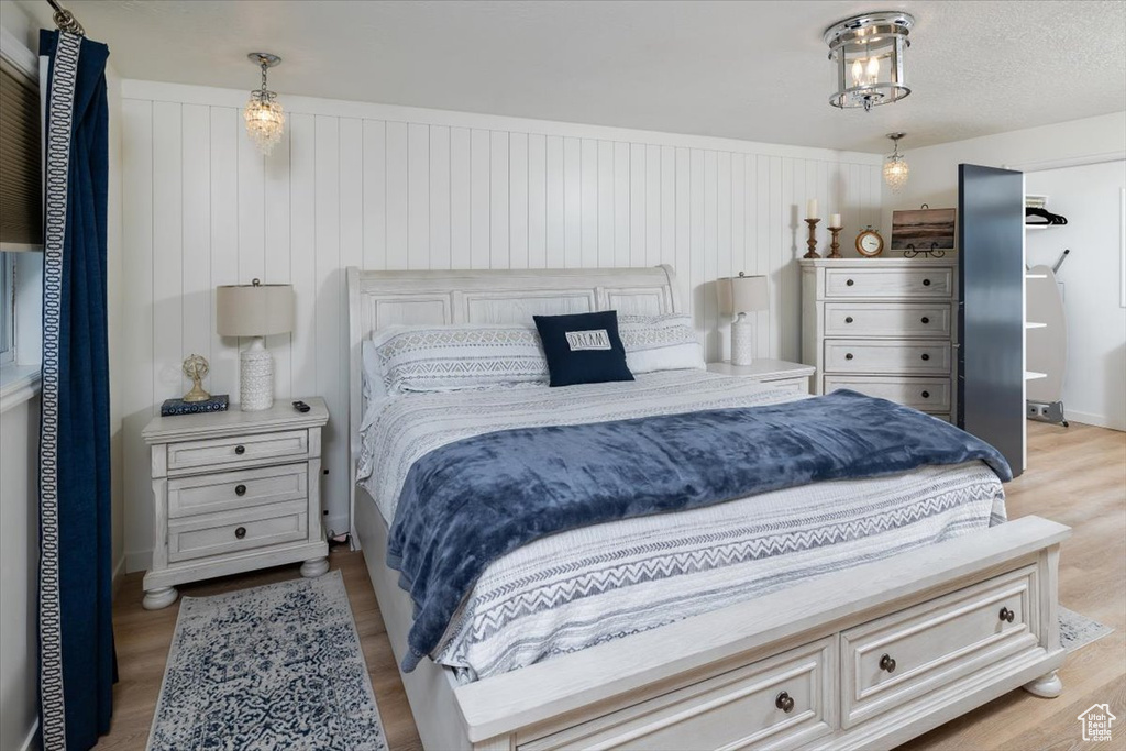 Bedroom featuring light hardwood / wood-style flooring and a textured ceiling