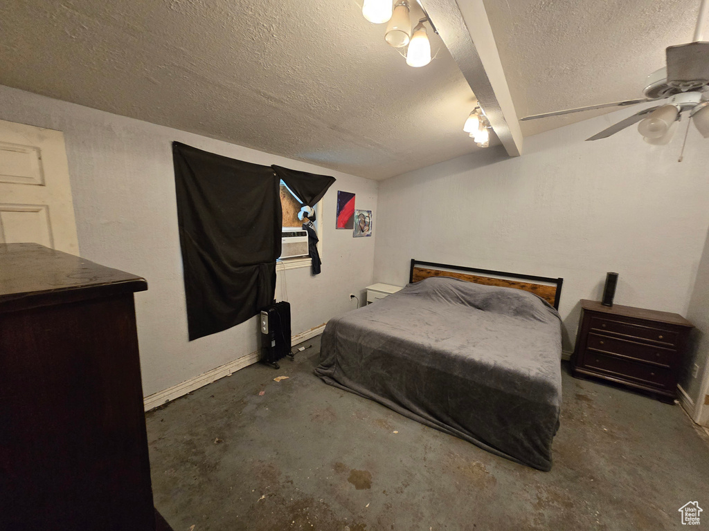Bedroom featuring a textured ceiling, concrete floors, and ceiling fan